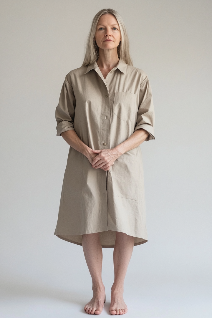 Model wearing The Kai Shirt Dress in soft stone cotton with an oversized fit and button-front closure.
