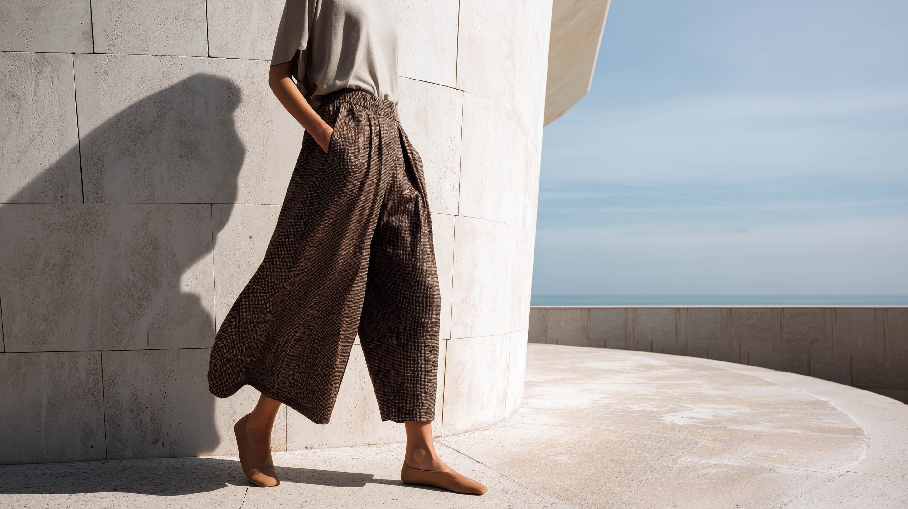 Model in taupe trousers and raw linen top